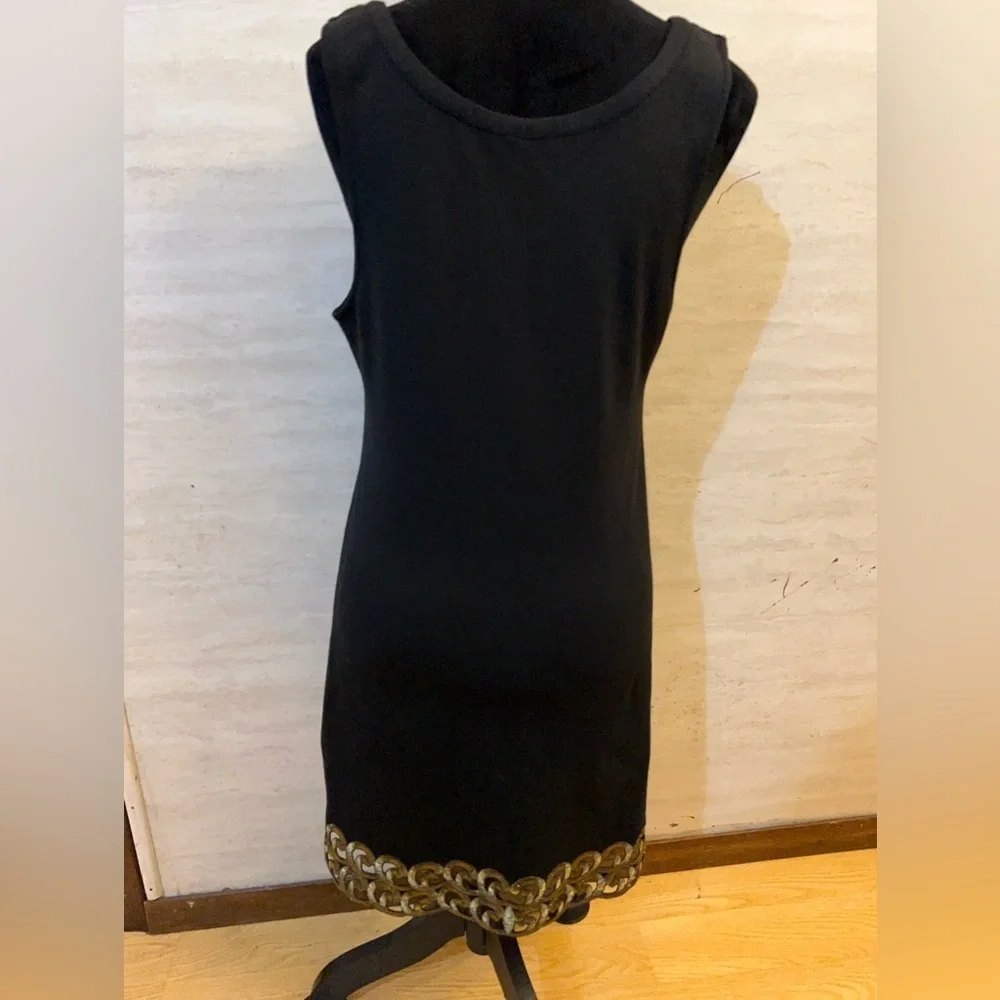 Free People sleeveless black dress with gold metallic embroidery.